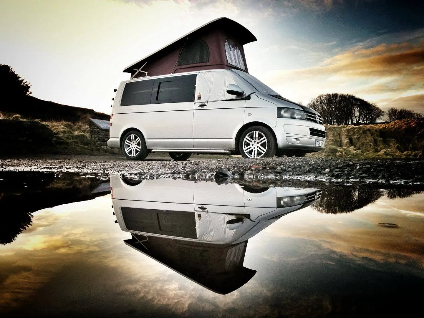 Volkswagen T6 pop top campervan reflected in water